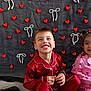 backdrop, boy, child, decoration, fabric, festive, girl, happy, hearts, indoor, pajamas, pearl_bows, portrait, red_pajamas, siblings, sitting, smile, smiling, watermark, young_child