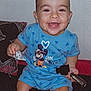 Ilyes a rejoint le concours — aidez-le/la à gagner de superbes lots ! toddler, child, smiling, blue_clothing, mickey_mouse, keys, couch, pillow, indoor, happy, sitting, shorts, toy, pattern, fabric, face, person, cute, baby, home