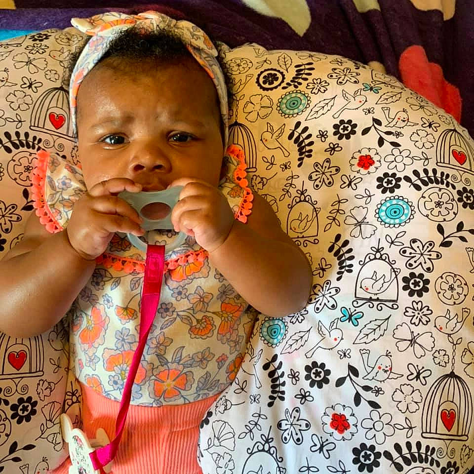 Dani is registered to the contest to win money with this photo: arm, baby_toddler_clothing, cheek, dress, ear, eyelash, finger, hairstyle, hand, happy, head, iris, lip, mouth, neck, nose, person, shirt, skin, sleeve