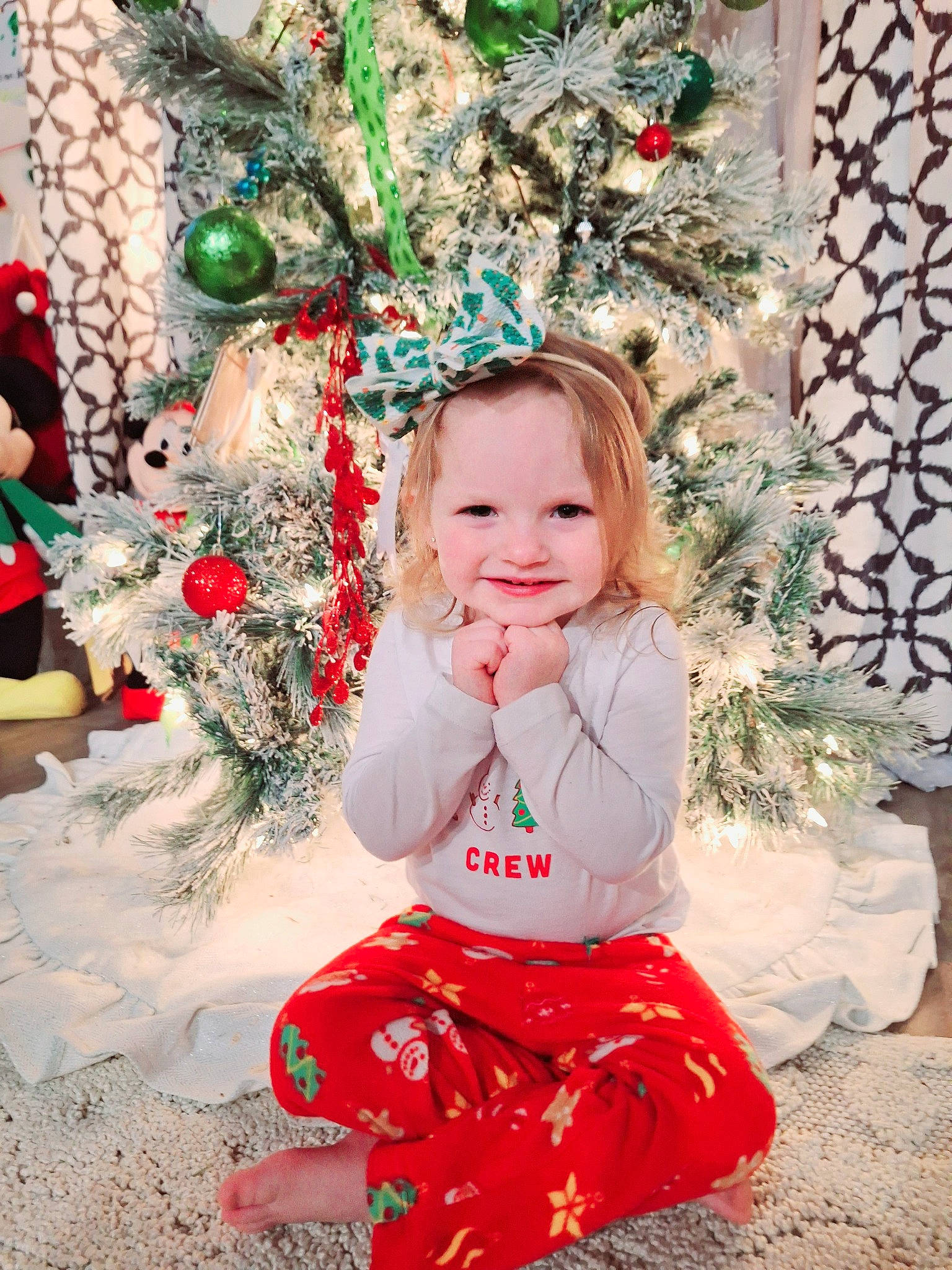 Charli is registered to the contest to win money with this photo: baby, baby_toddler_clothing, child, christmas_decoration, christmas_ornament, christmas_tree, event, fun, happy, holiday, holiday_ornament, interior_design, joy, ornament, pattern, people_in_nature, person, sitting, smile, toddler