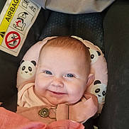 Isla-May is registered to the contest to win money with this photo: baby, smiling, face, infant, car_seat, panda_pattern, blanket, clothing, pink, head, seatbelt, child, indoors, cute, happy, safety, portrait, baby_bib, soft_toys, closeup