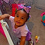 toddler, child, bow, purple, playpen, carpet, toy, smile, curious, indoors, footwear, bracelet, furniture, colorful, young_child, person, cute, happy, playing, baby