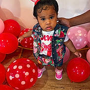 Heaven is registered to the contest to win money with this photo: toddler, child, balloons, red, pink, polka_dot, denim_vest, skirt, shoes, bow, hair, floor, hand, wooden_floor, indoor, person, clothing, cute, standing, support
