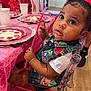 toddler, child, party, table, strawberry, plate, pink, bow, chair, curious, clothing, bracelet, decorations, cup, indoor, celebration, person, face, holding, wooden_floor