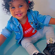 Heaven is registered to the contest to win money with this photo: black_sneakers, casual, child, curly_hair, cute, denim_jacket, fashion, hair_clips, happy, indoor, leggings, person, playful, portrait, red_shirt, sitting, smiling, studio, toddler, young_child