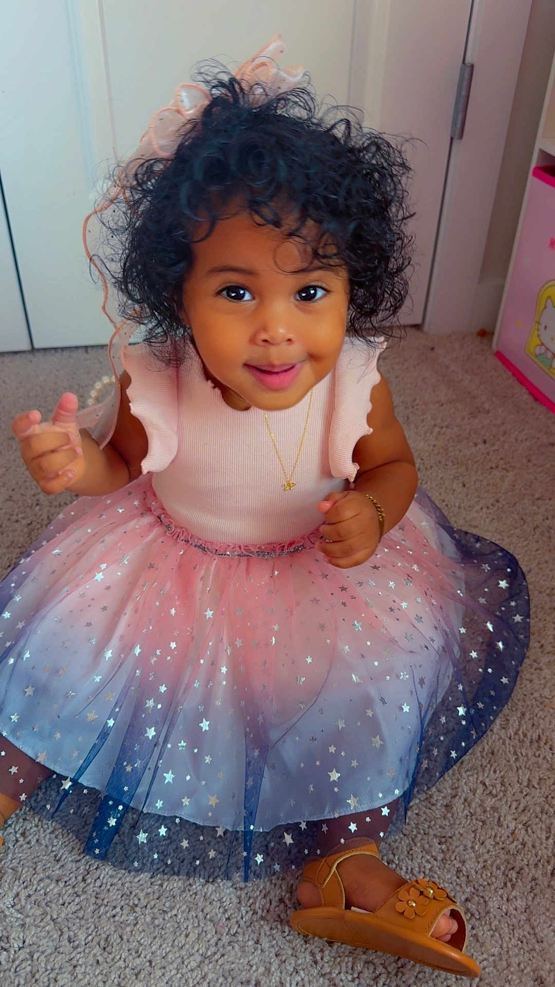 Heaven joined the competition — help win amazing prizes! toddler, child, smiling, curly_hair, dress, star_pattern, sandals, carpet, indoor, jewelry, necklace, bracelet, happy, cute, person, baby, fashion, playful, sitting, portrait
