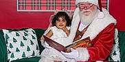 Heaven joined the competition — help win amazing prizes! black_boots, book, bow, carpet, child, christmas, curly_hair, festive, glasses, green_couch, holiday, indoor, pillow, plaid_background, portrait, reading, red_wall, santa_claus, smile, white_dress
