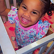 Heaven joined the competition — help win amazing prizes! baby_clothes, bow, child, crib, cute, face, furniture, hair, happy, indoor, infant, patterned_clothing, person, pink, playful, portrait, smiling, toddler, white, young_child