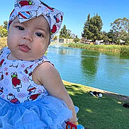 Aria joined the competition — help win amazing prizes! baby, child, headband, blue_dress, tutu, outdoor, pond, water, grass, duck, sunny, daylight, trees, park, cute, portrait, nature, colorful, person, smile