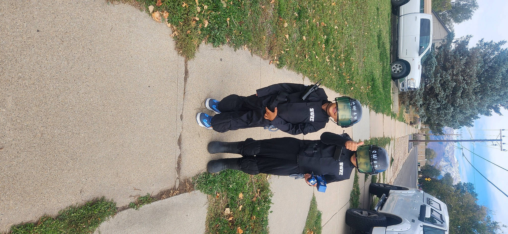 Eli joined the competition — help win amazing prizes! asphalt, automotive_lighting, boot, car, concrete, footwear, grass, headwear, human_leg, leisure, pedestrian, person, plant, recreation, road_surface, shadow, sidewalk, sneakers, street_light, tree