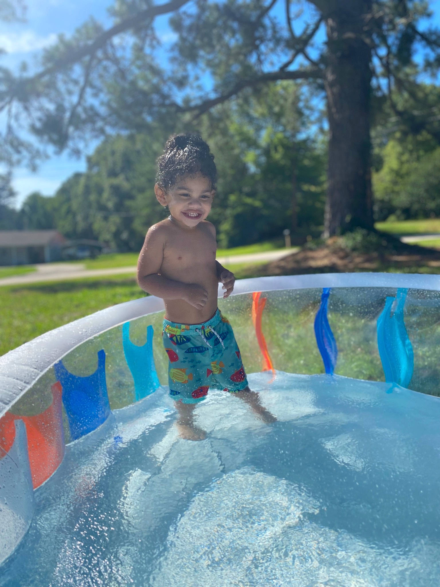 Bryson is registered to the contest to win money with this photo: aqua, azure, bathing, child, electric_blue, fun, happy, joy, leisure, nonbuilding_structure, person, plant, playground, public_space, recreation, sky, smile, summer, swimwear, toddler
