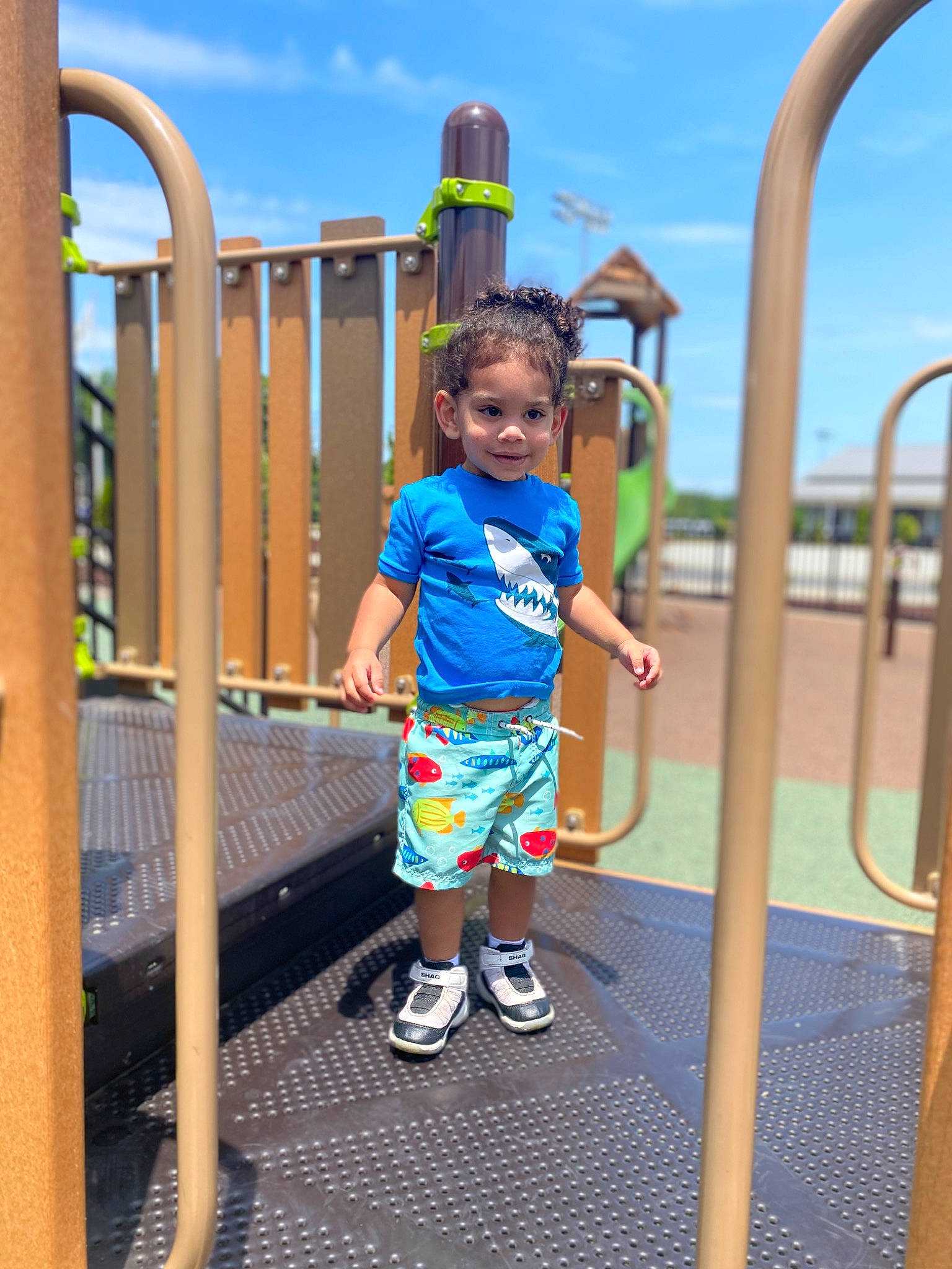 Kamdyn is registered to the contest to win money with this photo: child, city, electric_blue, footwear, fun, handrail, happy, leisure, nonbuilding_structure, outdoor_play_equipment, person, play, playground, recreation, shorts, sky, sneakers, t_shirt, toddler, travel