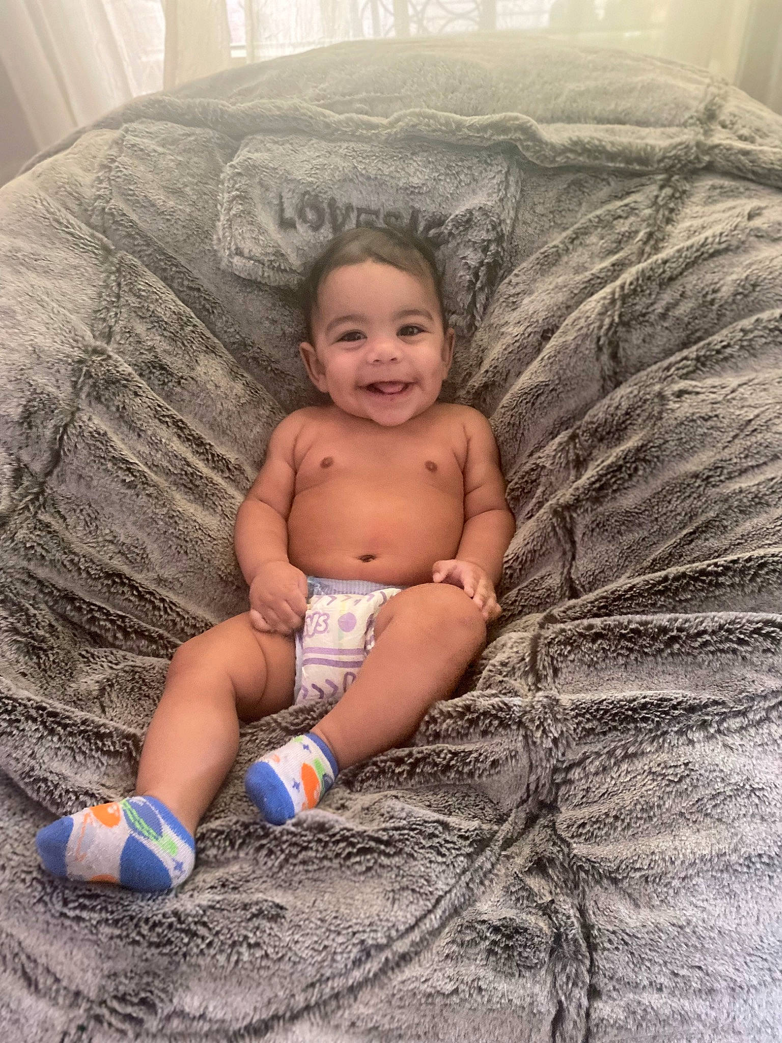 Kamdyn is registered to the contest to win money with this photo: abdomen, arm, baby, chest, comfort, couch, eye, finger, hand, human_body, joy, leg, mouth, muscle, person, skin, smile, stomach, thigh, toddler