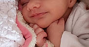 Nina participe au concours pour gagner de l'argent avec cette photo : baby, sleeping, blanket, pink, white, infant, cozy, soft, cute, newborn, closeup, face, peaceful, hand, wrapped, portrait, child, smile, warm, resting