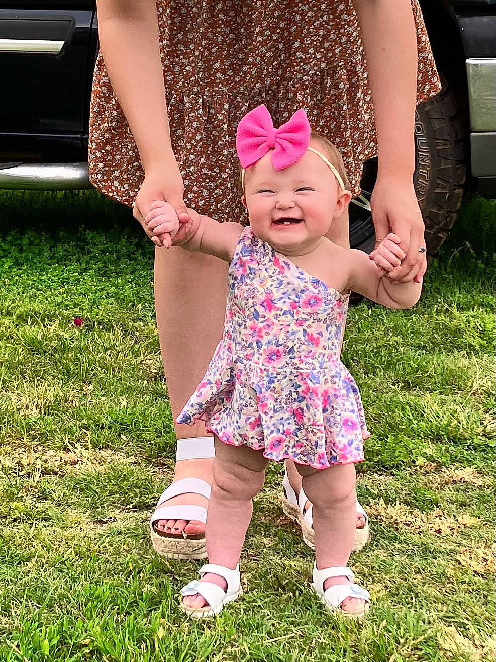 Kennedy is registered to the contest to win money with this photo: baby, baby_toddler_clothing, child, gesture, grass, grass_family, happy, hat, headwear, human_leg, joy, lawn, leisure, magenta, pattern, people_in_nature, person, pink, plant, shoe