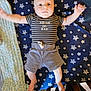 baby, bed, bedroom, clothing, couch, crib, cushion, face, furniture, head, homedecor, indoors, infantbed, pajamas, pants, person, photography, portrait, shorts, t_shirt
