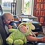 baby, child, sippy_cup, stuffed_animal, plush_toy, couch, leather, living_room, lamp, window, door, foot, hand, toy, indoor, person, cute, relaxing, furniture, home