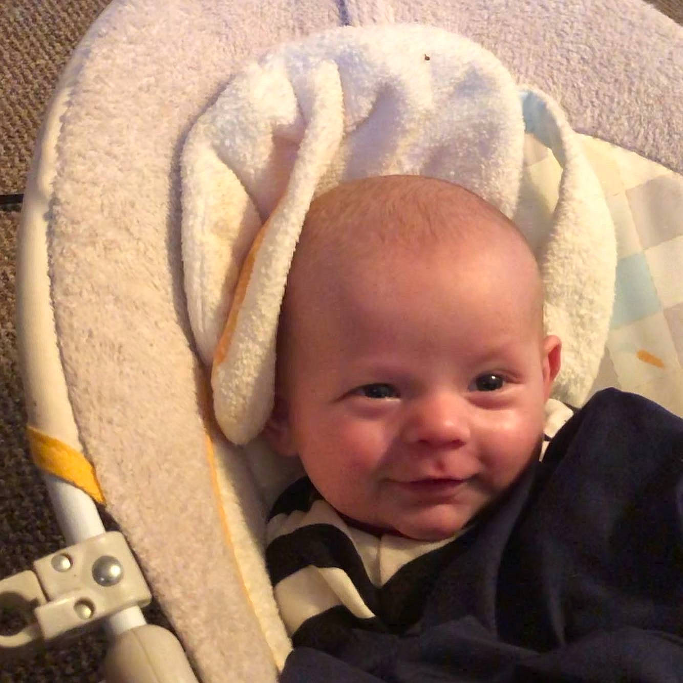 Jensen is registered to the contest to win money with this photo: baby, baby_in_car_seat, baby_products, baby_sleeping, cheek, child, comfort, ear, face, head, nose, person, product, skin, smile, toddler