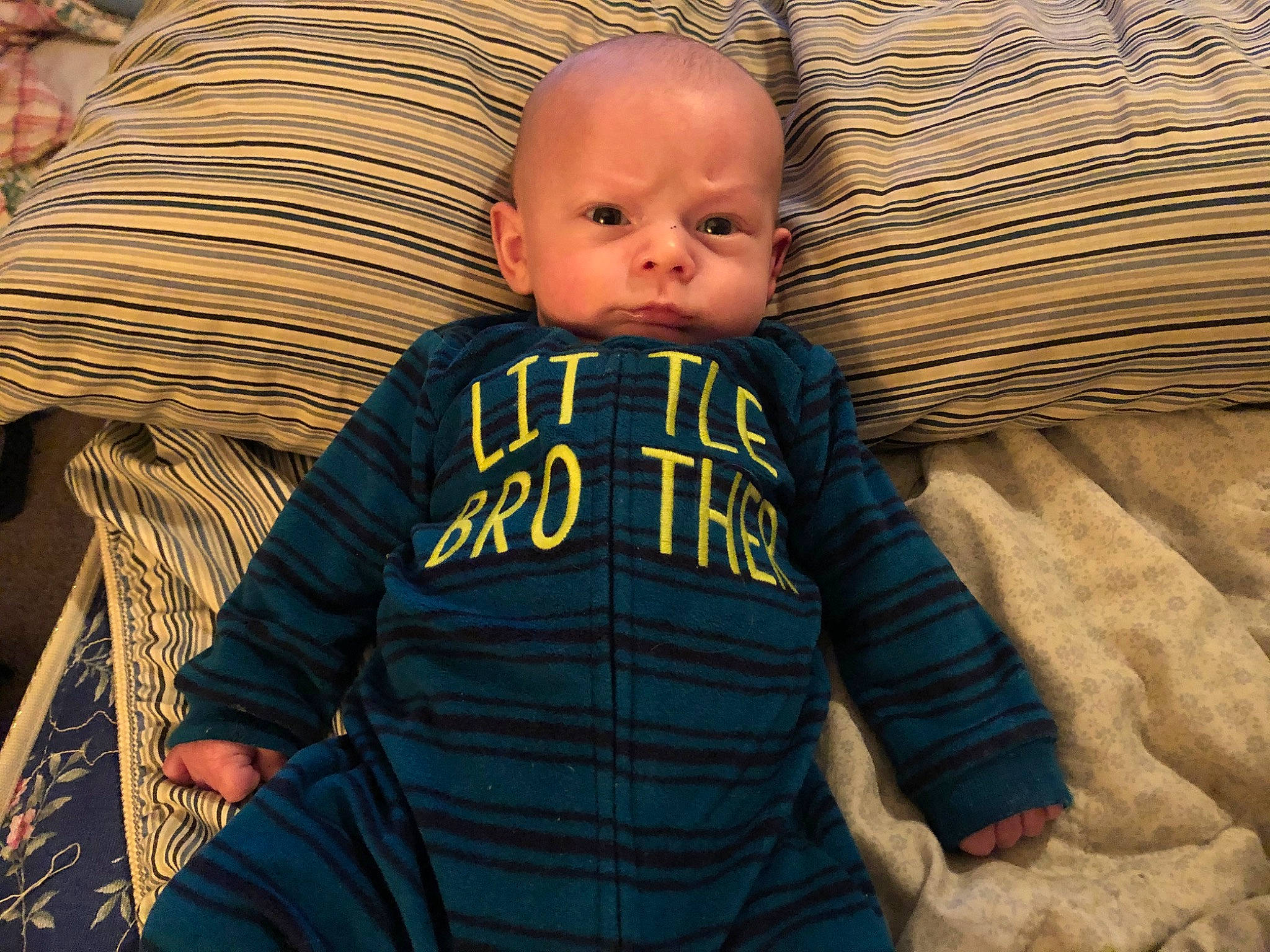 Jensen is registered to the contest to win money with this photo: baby, baby_products, cheek, child, cool, eye, face, green, head, human, iris, mouth, nose, organ, outerwear, person, product, sitting, skin, sleeve