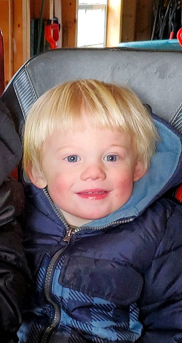 Cole is registered to the contest to win money with this photo: baby, bangs, blond, cheek, child, chin, comfort, electric_blue, eye, eyelash, fun, hairstyle, happy, iris, jacket, joy, outerwear, oval, person, sitting