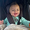Kingston is registered to the contest to win money with this photo: baby, blanket, child, clothing, cute, expression, face, happy, indoors, infant, joy, person, portrait, seatbelt, secure, smiling, stroller, toddler, warm, young