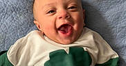 Kingston joined the competition — help win amazing prizes! baby, blanket, blue, child, clothing, curly_hair, cute, face, green, hand, happy, infant, joyful, lying_down, person, portrait, shirt, smiling, toddler, white