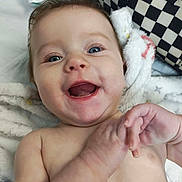Arabella joined the competition — help win amazing prizes! baby, infant, smiling, happy, face, blue_eyes, hands, blanket, skin, hair, cheeks, mouth, teeth, closeup, person, toddler, indoor, candid, expression, joyful