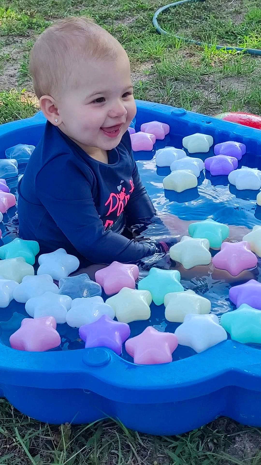 Delilah is registered to the contest to win money with this photo: azure, baby_toddler_clothing, blue, child, electric_blue, fun, green, happy, joy, leisure, light, nature, person, photograph, recreation, smile, snapshot, summer, toddler, toy