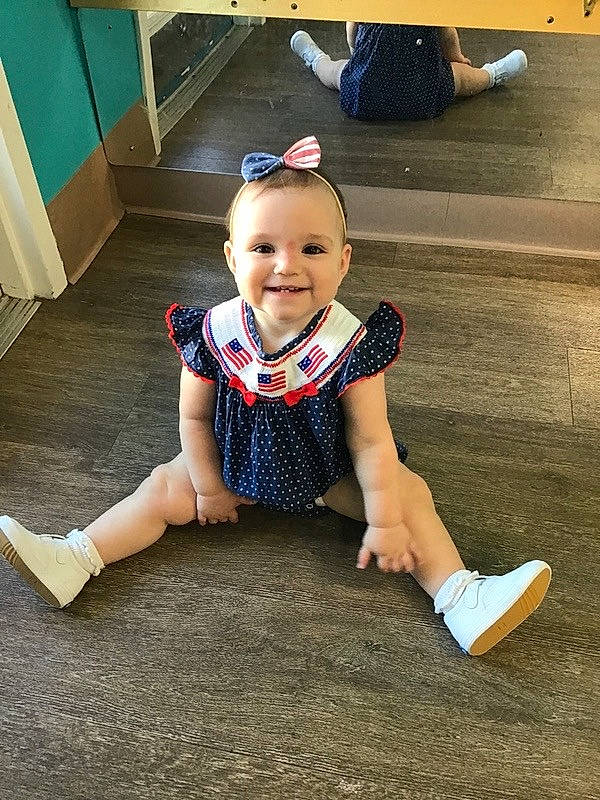 Lucy is registered to the contest to win money with this photo: baby, baby_toddler_clothing, child, electric_blue, floor, flooring, foot, fun, happy, hat, headgear, human_leg, joy, knee, leisure, person, shoe, sleeve, smile, sneakers