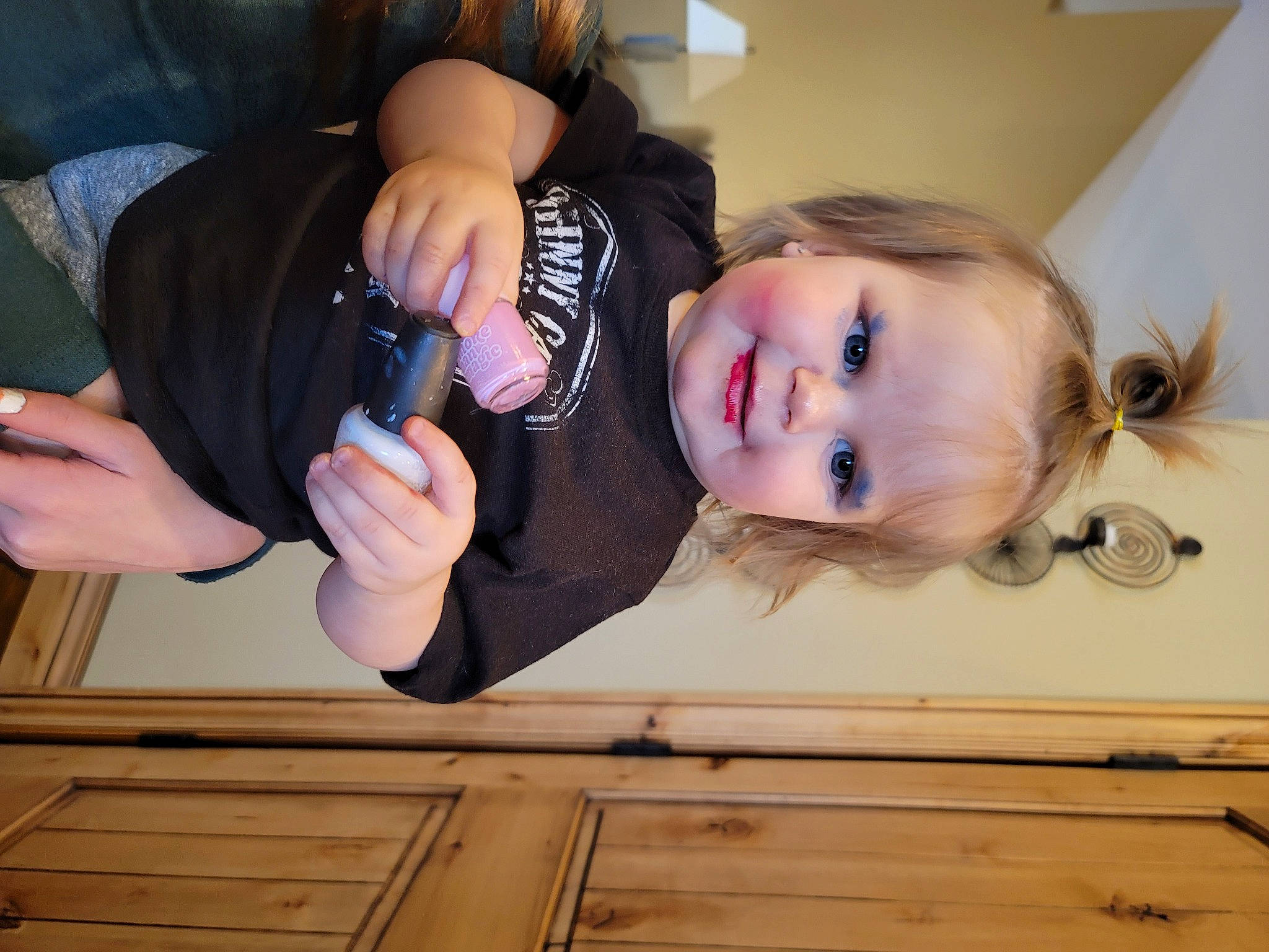 Anastyn is registered to the contest to win money with this photo: baby_toddler_clothing, child, comfort, door, flooring, fun, gesture, hand, happy, hardwood, joy, long_hair, person, shoulder, smile, tableware, thumb, toddler, varnish, wood
