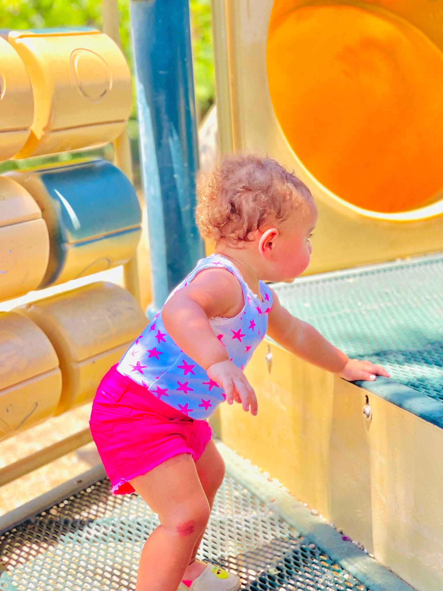 Zaryah is registered to the contest to win money with this photo: aqua, azure, blue, child, chute, electric_blue, fun, green, happy, human_leg, leisure, outdoor_play_equipment, person, pink, playground, public_space, recreation, red, thigh, toddler