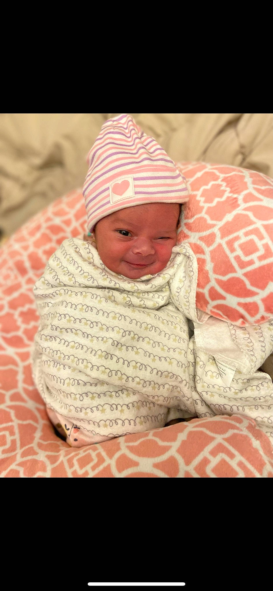 Kinzlee is registered to the contest to win money with this photo: baby, baby_toddler_clothing, cap, cheek, child, comfort, creative_arts, fashion_accessory, headgear, headwear, joy, knit_cap, linens, magenta, pattern, person, pink, skin, sleeve, smile