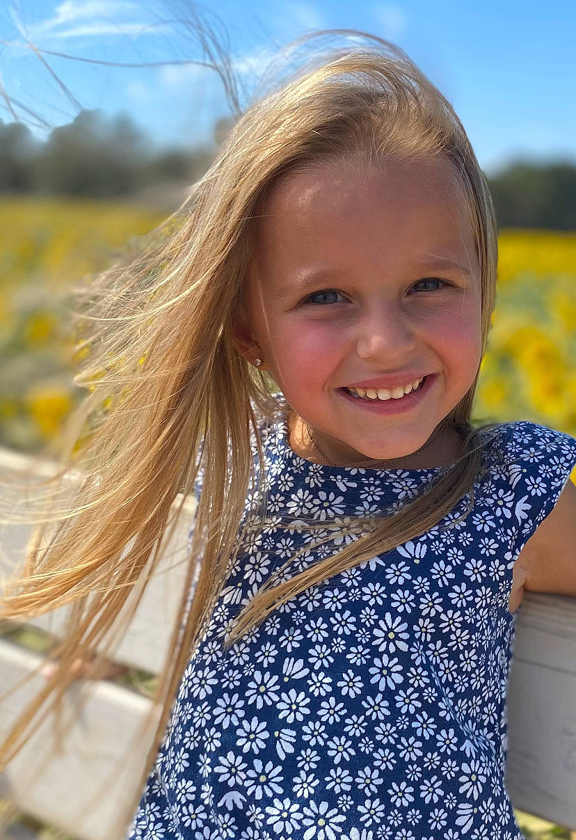 Amiya is registered to the contest to win money with this photo: blond, brown_hair, child, daytime, electric_blue, flash_photography, fun, grass, grassland, happy, iris, joy, lip, long_hair, pattern, people_in_nature, person, plant, skin, sky