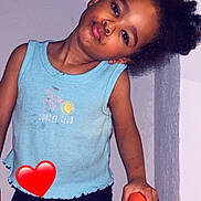 Cataleya participe au concours pour gagner de l'argent avec cette photo : casual_clothing, child, curly_hair, cute, expression, happy, indoor, kneeling, light, orange_chair, person, playful, portrait, red_heart_emoji, seat, shorts, smiling, tank_top, wall, young