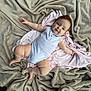 baby, infant, smile, face, red_hair, blanket, fabric, soft_texture, clothing, onesie, child, cute, relaxed, skin, lying_down, indoors, baby_girl, happy, portrait, toddler