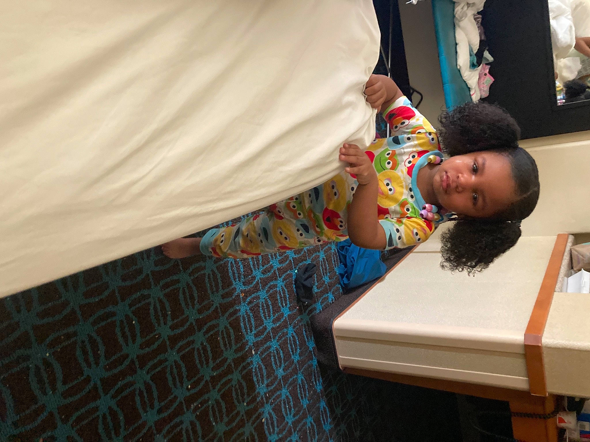 Tevana is registered to the contest to win money with this photo: baby, child, comfort, flooring, fun, happy, house, leisure, linens, office_supplies, pattern, person, picture_frame, play, reading, room, sitting, smile, t_shirt, toddler