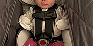 Emery is registered to the contest to win money with this photo: baby, infant, car_seat, pink_hat, bow, clothing, face, child, cute, looking_at_camera, safety_harness, foot, star_pattern, warm, indoor, person, adorable, newborn, seated, cozy