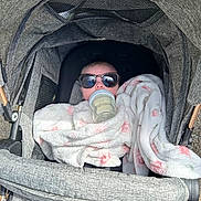 Hannah joined the competition — help win amazing prizes! baby, bottle, blanket, stroller, sunglasses, child, face, cozy, infant, outdoor, person, drink, cute, portrait, bundle, soft, comfort, babycare, relaxing, fashion