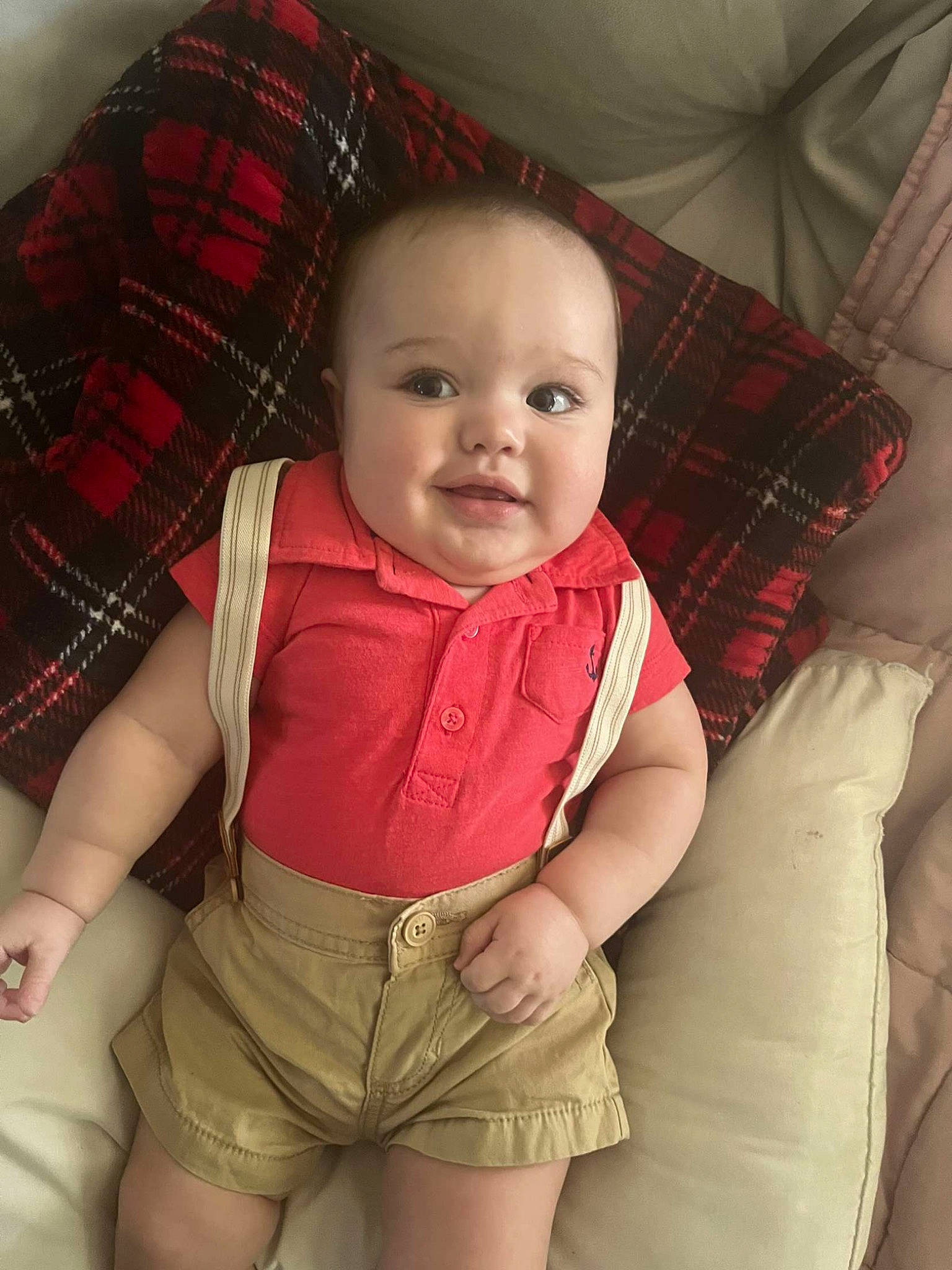 Kayson is registered to the contest to win money with this photo: arm, baby, baby_toddler_clothing, cheek, chin, comfort, eye, facial_expression, hairstyle, human_body, leg, lip, mouth, nose, person, product, skin, sleeve, smile, tartan