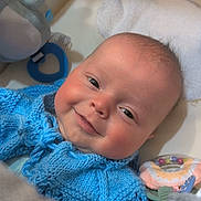 Lincoln joined the competition — help win amazing prizes! baby, smiling, blue_sweater, knitted_clothing, baby_seat, toy, towel, face, infant, cute, child, indoor, closeup, happy, soft_texture, colorful, comfort, newborn, portrait, resting
