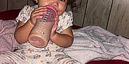 Anaya is registered to the contest to win money with this photo: baby, bed, bedroom, beverage, bodypart, coffee, coffeecup, couch, cup, face, finger, furniture, hand, head, indoors, milk, person, photography, portrait, room