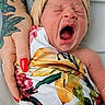 Phoenix is registered to the contest to win money with this photo: newborn, baby, yawning, wrapped, blanket, floral_pattern, head_wrap, tattoo, hand, red_nails, skin, infant, cute, sleepy, portrait, closeup, person, colorful, cozy, resting