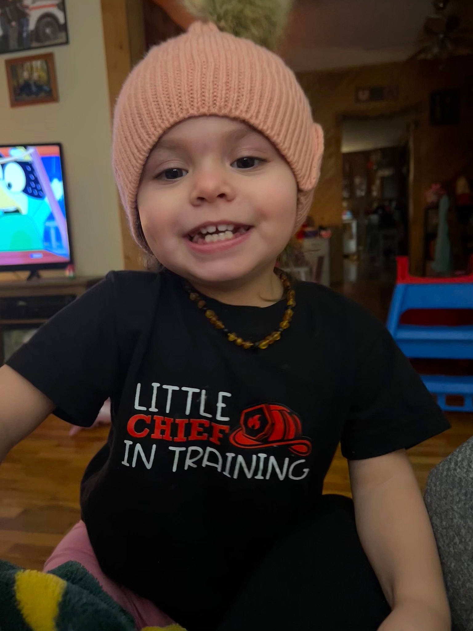 Elizabeth joined the competition — help win amazing prizes! beanie, cap, child, cool, display_device, eye, fashion_accessory, fun, happy, headgear, headwear, helmet, holiday, joy, knit_cap, person, personal_protective_equipment, room, sleeve, smile