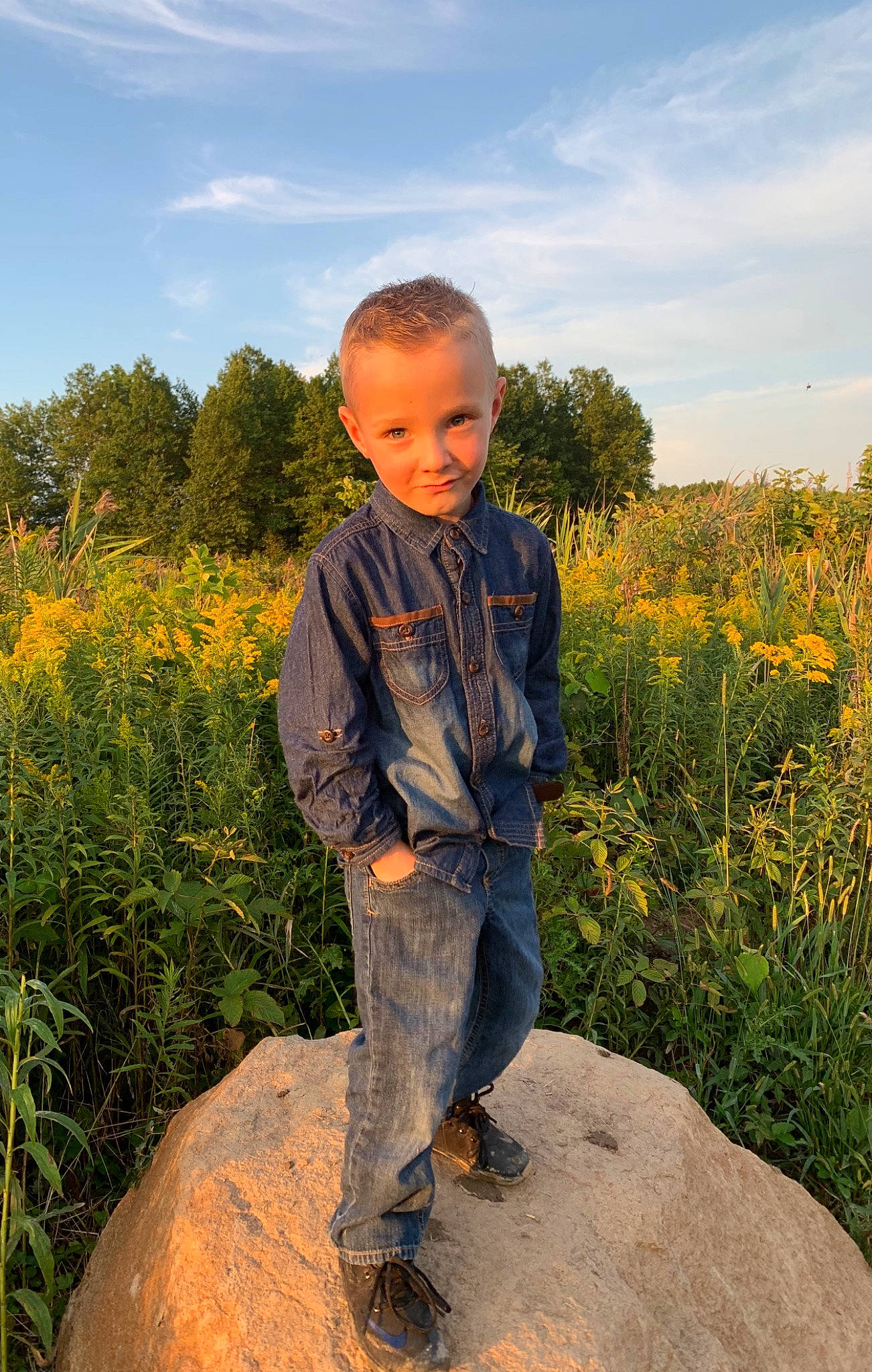 Lyam is registered to the contest to win money with this photo: agriculture, cloud, electric_blue, field, flower, grass, grass_family, grassland, happy, joy, landscape, natural_environment, natural_landscape, people_in_nature, person, plant, prairie, rural_area, sky, standing