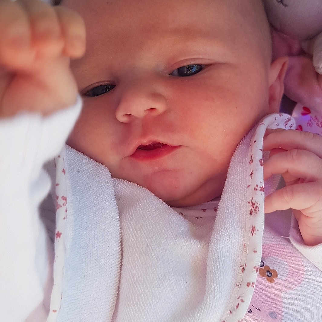 Elyana participe au concours pour gagner de l'argent avec cette photo : baby, baby_toddler_clothing, cheek, chin, collar, comfort, eyelash, finger, gesture, lip, mouth, neck, nose, pink, product, skin, sleeve, textile, toddler, white