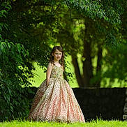 Sydney is registered to the contest to win money with this photo: child, clothing, dress, eveningdress, face, fashion, female, formalwear, girl, gown, grass, happy, head, lady, person, plant, sitting, standing, wedding, weddinggown
