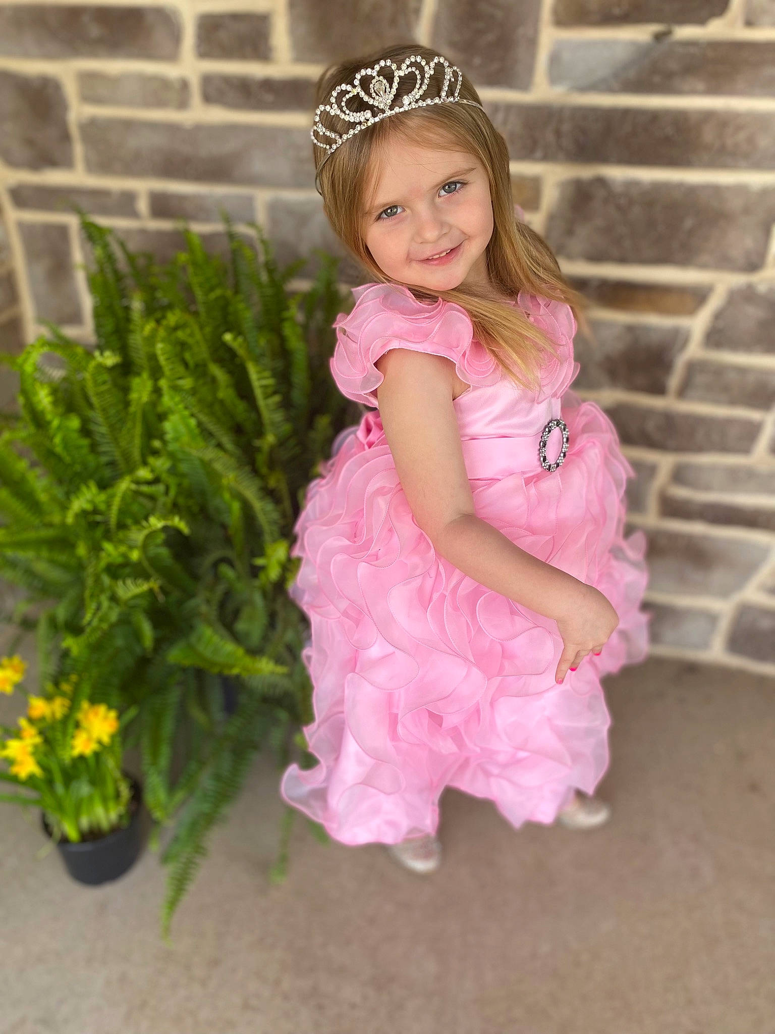 Haisley is registered to the contest to win money with this photo: baby_toddler_clothing, day_dress, dress, face, flower, flowerpot, grass, hair, hairstyle, happy, headpiece, houseplant, jewellery, joy, magenta, person, pink, plant, sleeve, smile