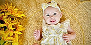 Mckinlyn joined the competition — help win amazing prizes! baby, infant, smile, headband, flower, woven_mat, sunflowers, yellow, cute, child, portrait, laying_down, clothing, happy, skin, hand, face, eyes, indoor, decor