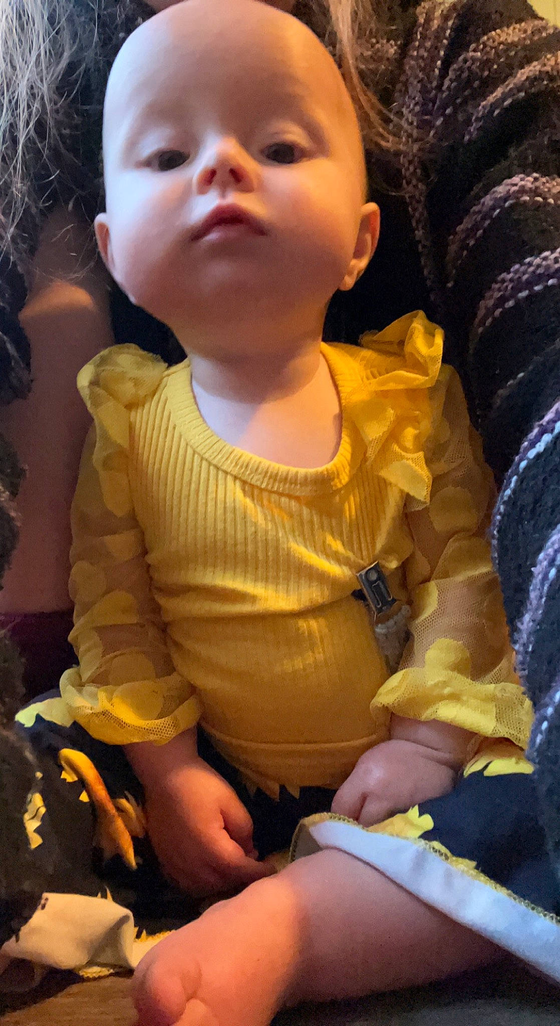 Kaia is registered to the contest to win money with this photo: arm, baby_toddler_clothing, cheek, chin, comfort, cool, facial_expression, finger, hand, happy, head, iris, lip, neck, nose, person, skin, sleeve, textile, thigh