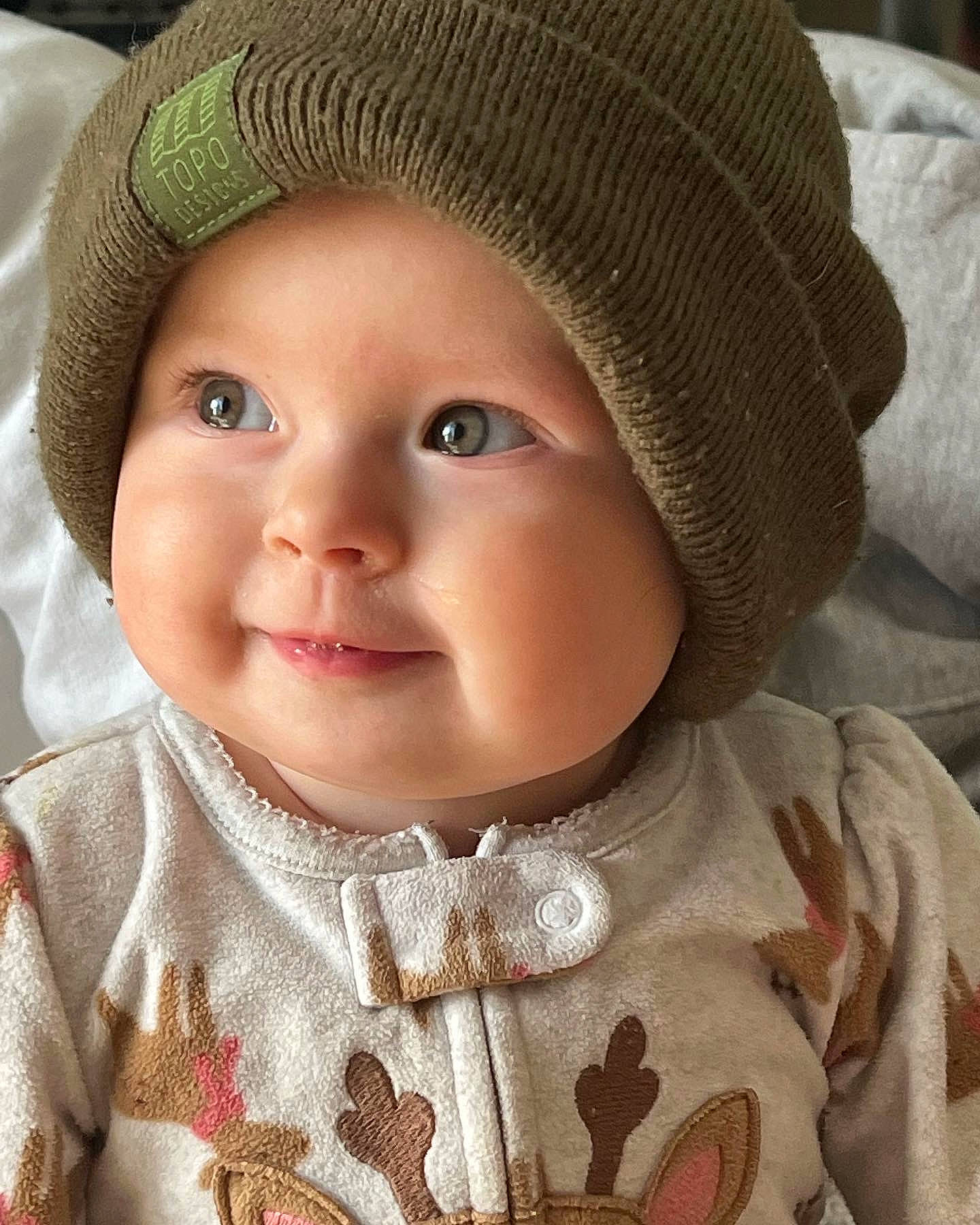 Kaia is registered to the contest to win money with this photo: baby, baby_toddler_clothing, cap, cheek, chin, eye, eyebrow, face, hat, head, headwear, iris, lip, nose, organ, outerwear, person, photograph, skin, sleeve